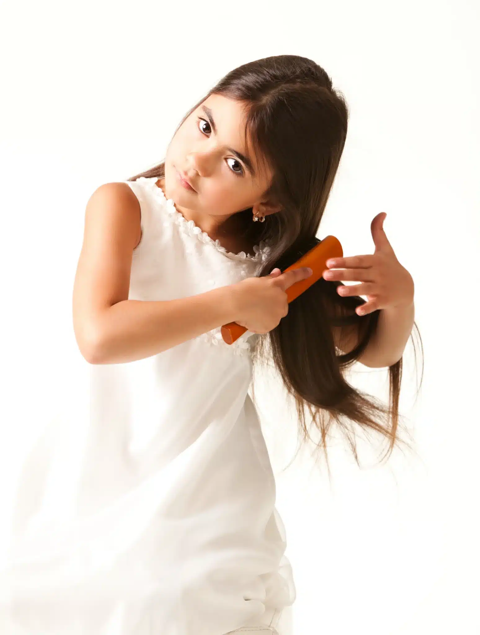Lavallette girl in white dress combing brown hair scaled