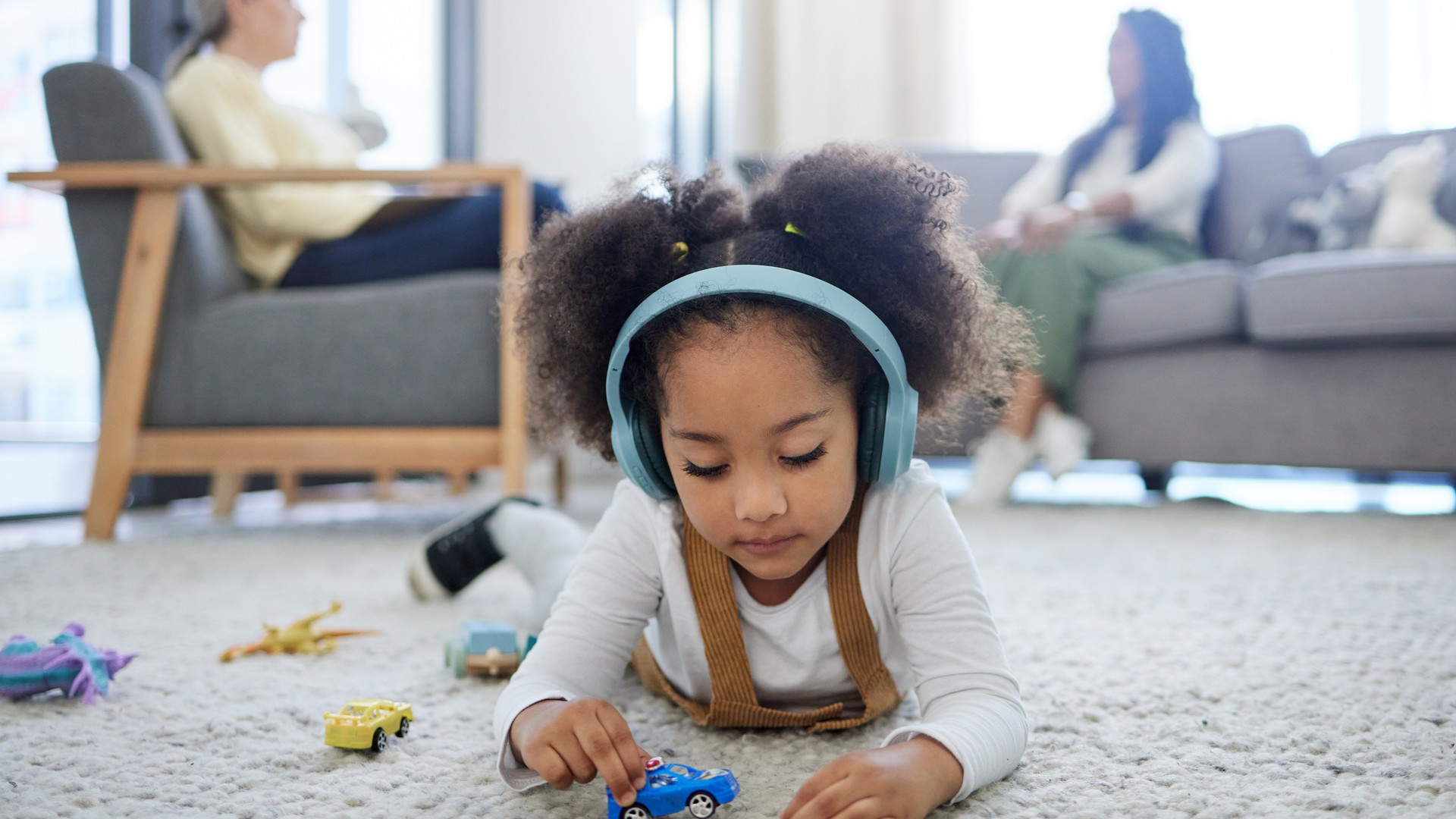 Child wearing noise-reducing headphones during a sensory-friendly care session