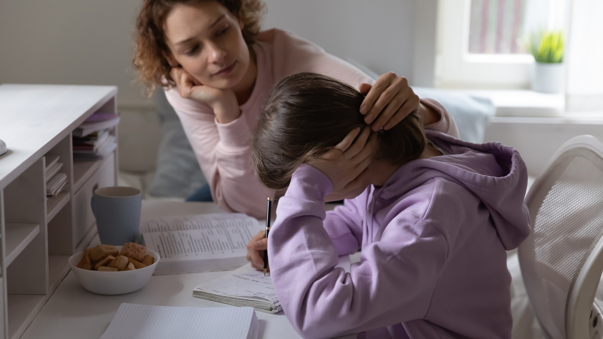 Parent supporting an overwhelmed child during a stressful head lice experience