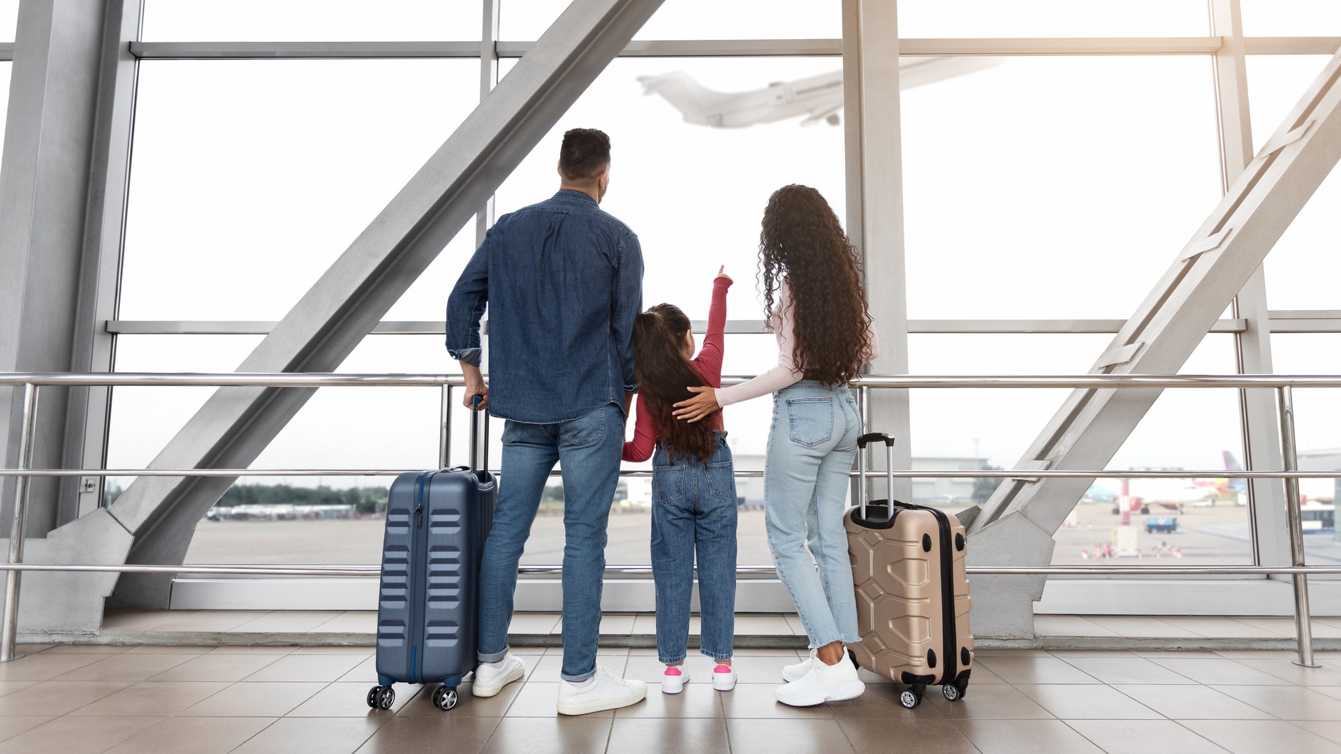 Family traveling together through an airport during the holiday season