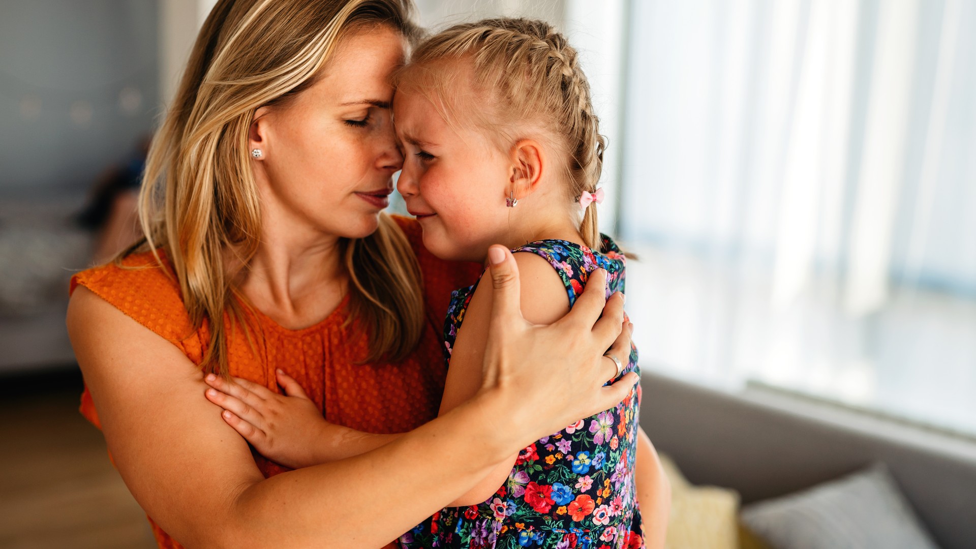 Mother comforting a child who feels upset about a head lice diagnosis