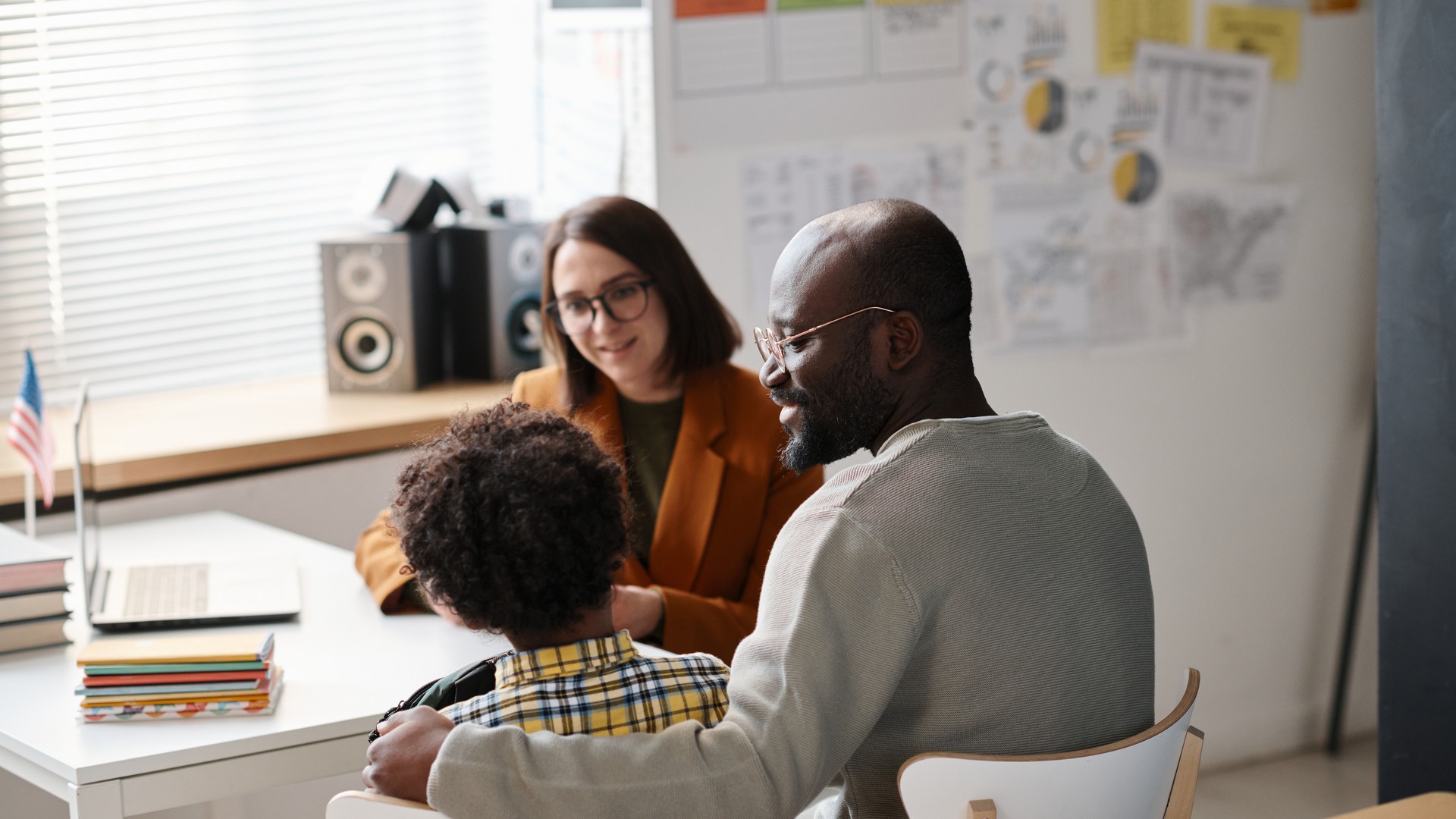 Parent and child meeting with a teacher about a head lice case
